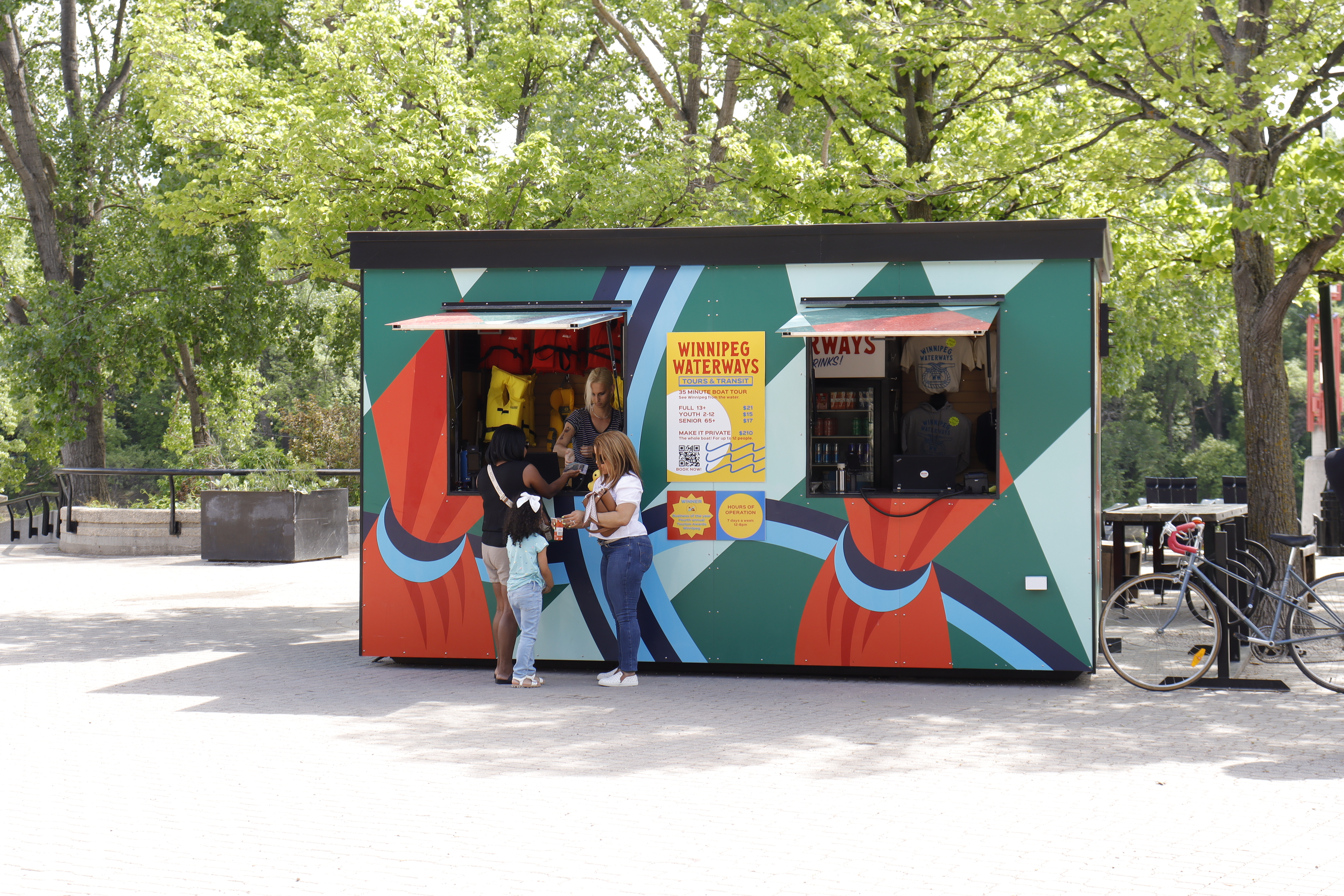 A family standing in front of the Entertainment Kiosk.
